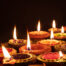 Diwali, Hindu festival of lights celebration. Diya oil lamps against dark background,