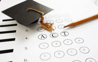 ACT college entrance test with pencil and graduation cap