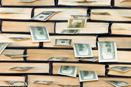 wall of books with money sticking out of each book
